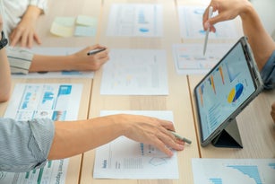 Close-up shot of Business Colleagues teamwork analyzing financial data at the table in modern office about business strategies.