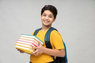 Photo of school boy wear yellow t-shirt backpack in background, stock photo