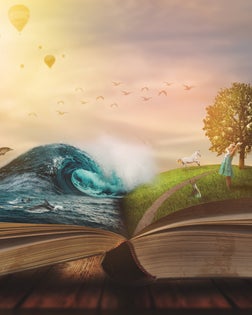 Concept of an open magic book; open pages with water and land and small child. Fantasy, nature or learning concept, with copy space
