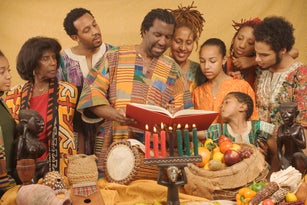 Family lighting candles celebrating Kwanzaa