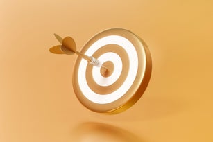 Golden arrow aim to dartboard target or goal of success on business background with complete achievement concept. 3D rendering.