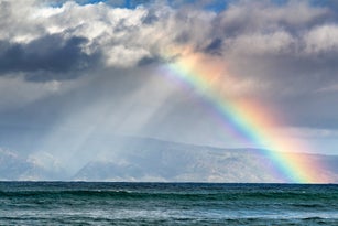 Scenic View Of Rainbow Over Sea Against Sky