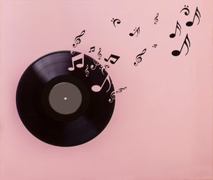 Vinyl record on pink background. Several musical notes are born of the vinyl record