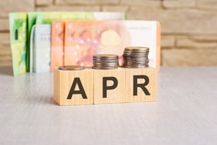 business concept. cubes with the inscription - APR. euro and monet on grey table