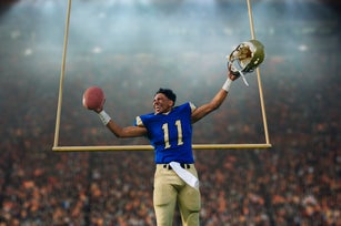 Teenage American football player celebrating victory in soccer stadium