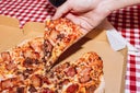 Man holding pizza slice