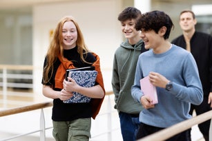 Teenage school students walking in hallway