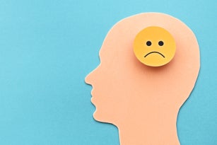 Head of a man with the sign of a sad face. The concept of negative mood and discontent.