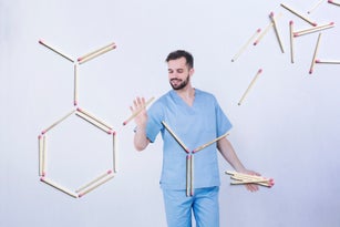 Young scientist building a chemical symbol
