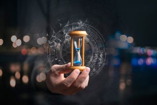 time management concept, businessman holding hourglass