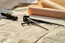 Old sailing desktop with precision compass measure tool, letter and historical documents