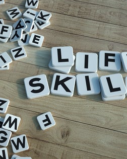 Life skills written in letter tiles wood