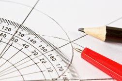 Protractor, compasses and pencil on diagram, all in close-up