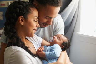 Couple cradling newborn baby
