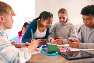Secondary Or High School Students In Study Area Working Together Using Mobile Phones