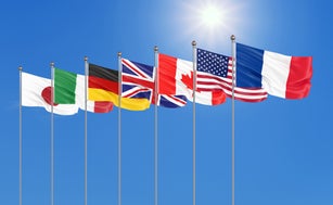 Silk waving G7 flags of countries of Group of Seven Canada, Germany, Italy, France, Japan, USA states, United Kingdom. Blue sky background. Big G7 in France 2019. 3D illustration.