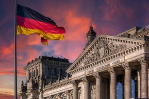 Deutscher Bundestag - Reichstag building and German flag at sunset (German parliament building) - Berlin, Germany