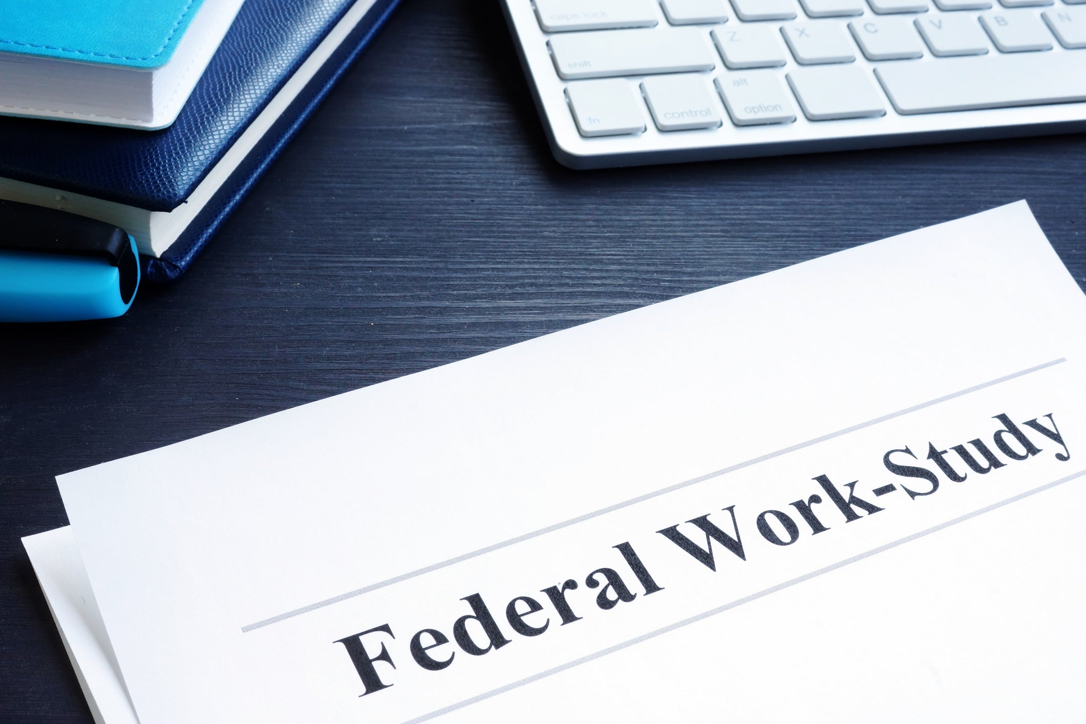 Federal Work Study FWS program documents and pen.