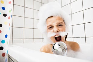 Boy playing in bubble bath