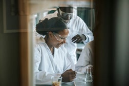 Happy students doing science experiment in laboratory