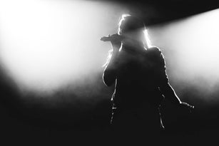 Silhouette Of Person With Arms Raised