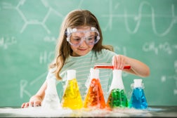 Caucasian girl doing science experiment in classroom