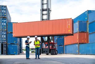 Workers are having a discussion about cargo containers