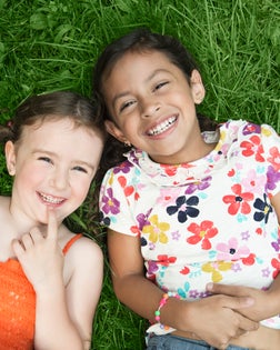 Girls laying in grass