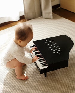 Baby boy playing small piano