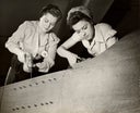 Women working on WW II aircraft assembly
