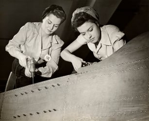 Women working on WW II aircraft assembly