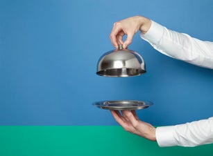 hands holding silver tray and lid