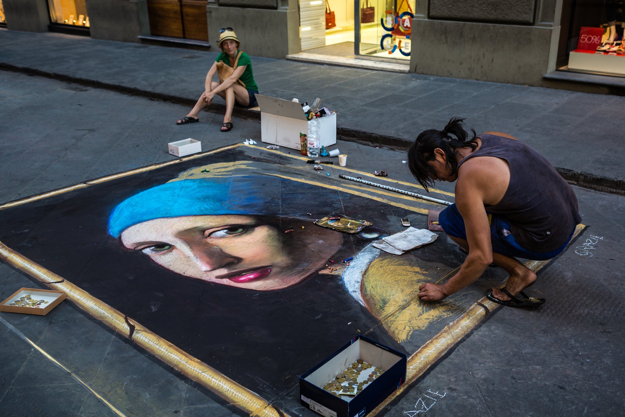 Street artist drawing the Girl with a Pearl Earring