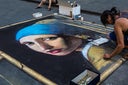 Street artist drawing the Girl with a Pearl Earring