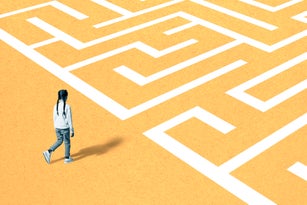 Girl walking towards maze on yellow surface