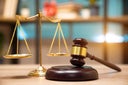 Business and lawyers discussing contract papers with brass scale on desk in office. Law, legal services, advice, justice and law concept picture with film grain effect