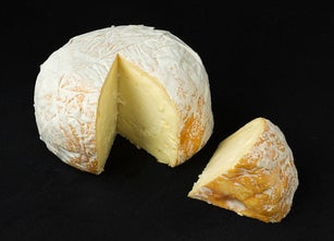 cured cheese on a black background
