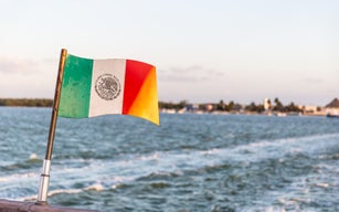 Mexican flag on the back of a ship sailing in the Gulf of Mexico