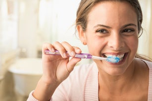 Caucasian woman brushing her teeth