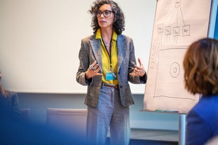 Female professional giving a presentation in a seminar