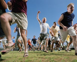 Crowd of men running, low angle