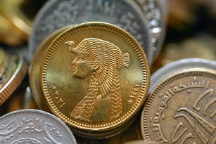 The obverse side of Egyptian 50 fifty piasters 2021 AD, 1442 AH, on a blurred multiple coins background