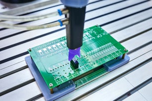 Robotic Arm Installing Component at Circuit Board