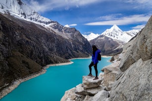 Tourist woman staring at the amazing Lake Paron in Cordillera Blanca of Peru