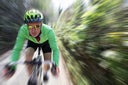 Man cycling down country road