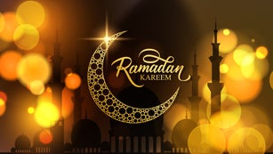 Ramadan Kareem festive banner. Muslim holy month greetings. Hand lettering, blurred bokeh lights and gold crescent moon.