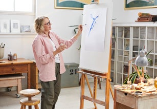 Senior woman painting at her home studio