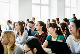University Students Listening And Concentrating During Lecture