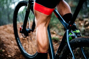 Close-up of mountainbiker on forest trail