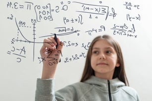 Teenage girl solving mathematical problems